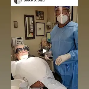 Dr. Blau with patient wearing mask and sheild